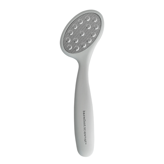 Smooth Things Over | Barefoot Scientist foot file with ergonomic white handle and textured gray abrasive surface for effective skin smoothing and care.